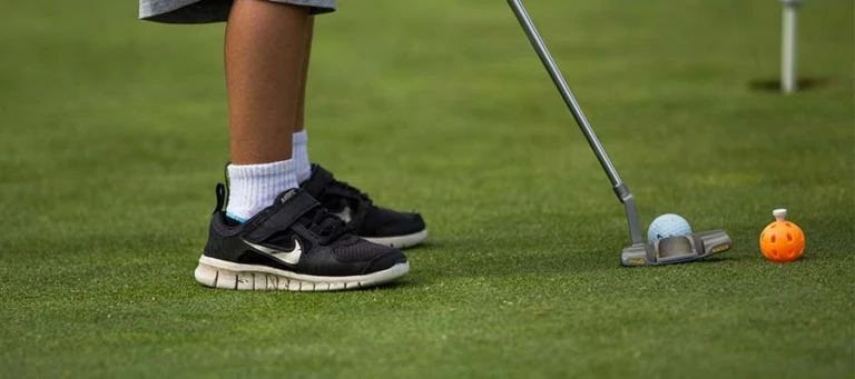 Pine Ridge camper putting on practice green