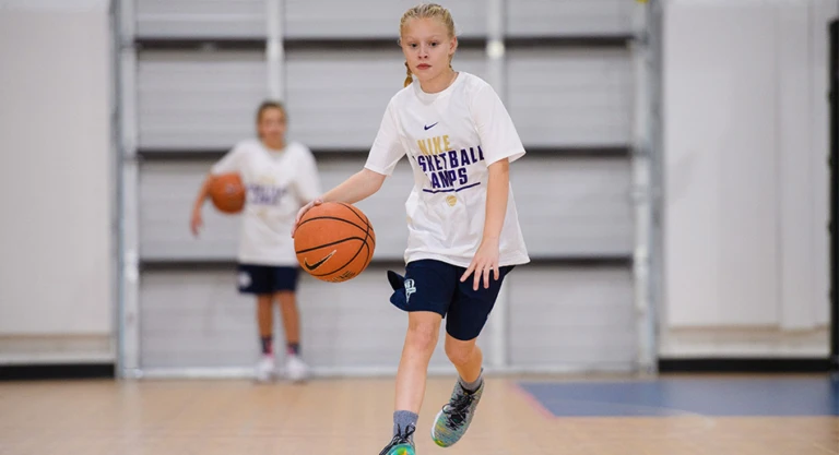 Girl dribbling at half court