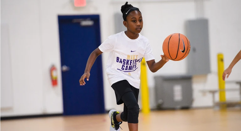 Girl looking up toward basket