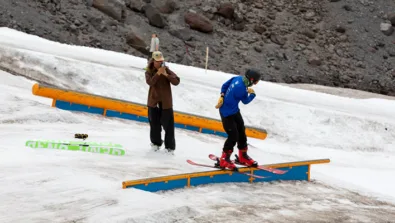 Windells Ski Camp camper learns to ride flat bar with coaches help jpg
