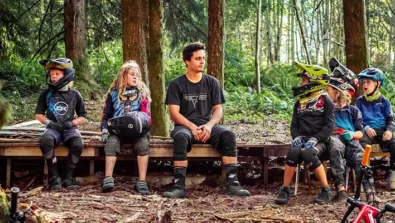 Grom campers sitting with coaches milepost 35