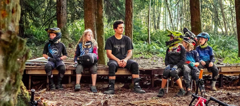 Grom campers sitting with coaches milepost 35