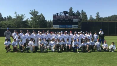Nike Baseball Campers and coaches pose in outfield of Merkel Field for group picture
