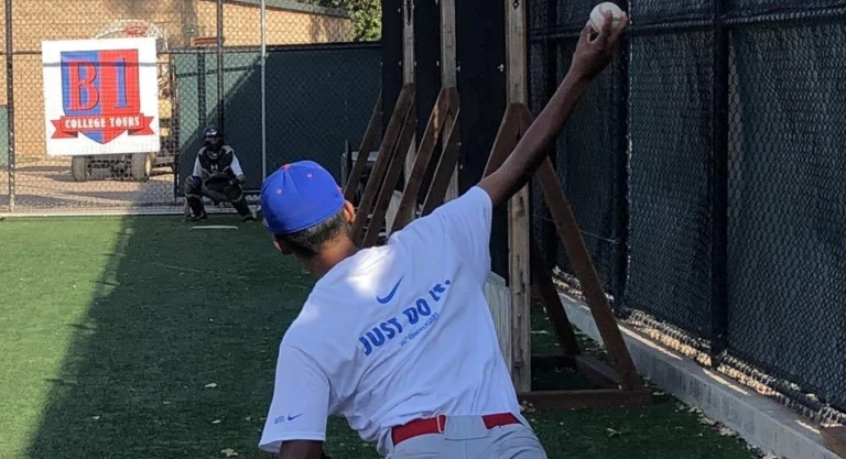 Nike Baseball camper pitching to catcher in the bullpen