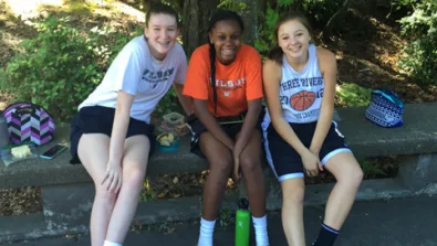 Lewis Clark College girls smiling and making friends at youth basketball camp in oregon
