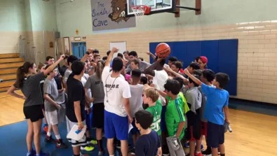 Brown Middle School youth basketball camp team huddle
