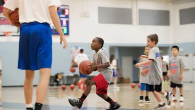 St. Ignatius Basketball camp showing a camper driving to the hoop