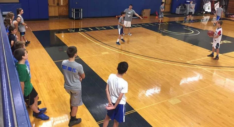 Saint Anselm College campers doing basketball drills