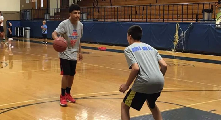 Saint Anselm College youth boys doing one on one basketball scrimmage