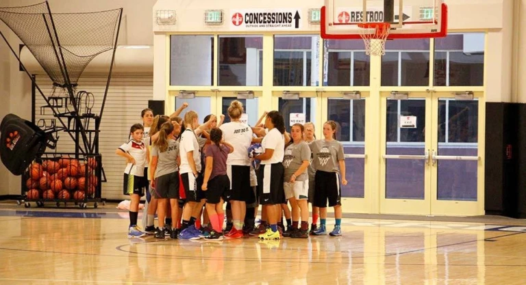 WJU girls nike basketball camp team huddle at the summer youth basketball camp