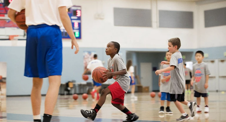 St. Ignatius Basketball camp showing a camper driving to the hoop