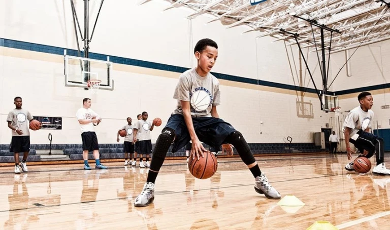 Boys Dribble Between Legs at the youth summer basketball camp