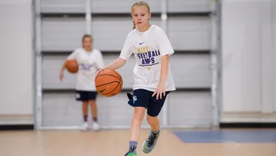 Girl dribbling at half court