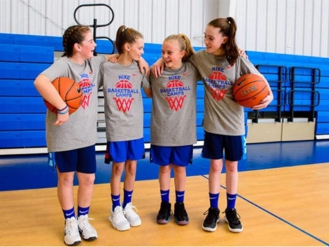Teammates at a basketball youth camp having serious fun!