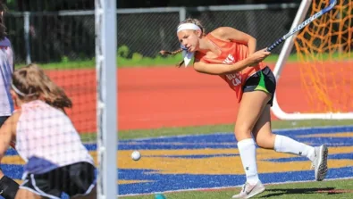Worcester State Field Hockey Girl Hitting Ball