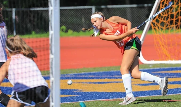 Worcester State Field Hockey Girl Hitting Ball