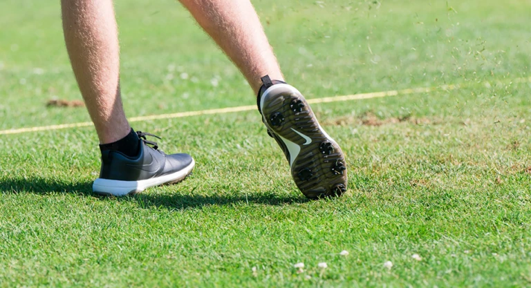 Nike Junior Golf Camp tee shot close up grass flying