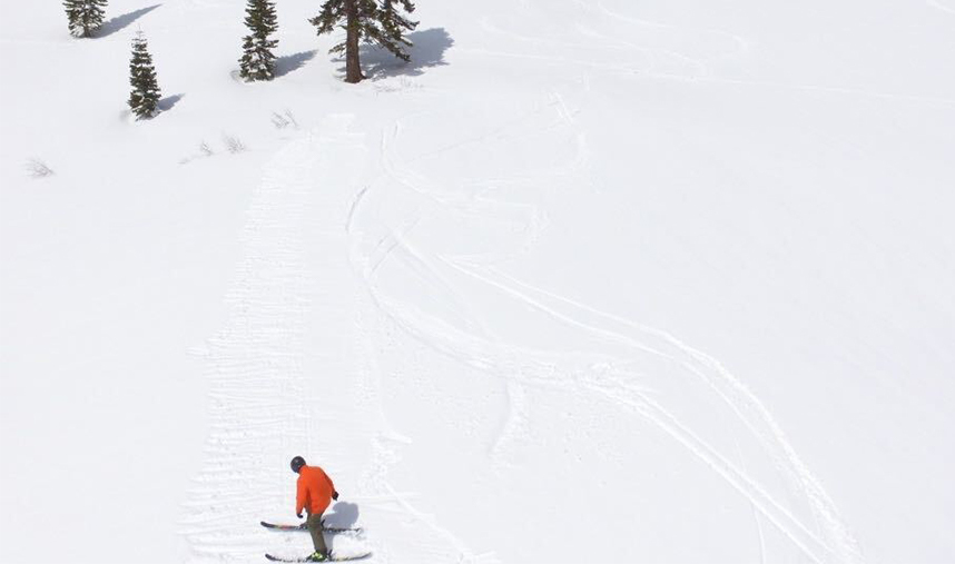 Camper perfecting their form hitting a jump in the back country at Lake Tahoe Our ski camps are offered at Mt Hood all summer long