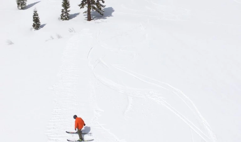 Camper perfecting their form hitting a jump in the back country at Lake Tahoe Our ski camps are offered at Mt Hood all summer long