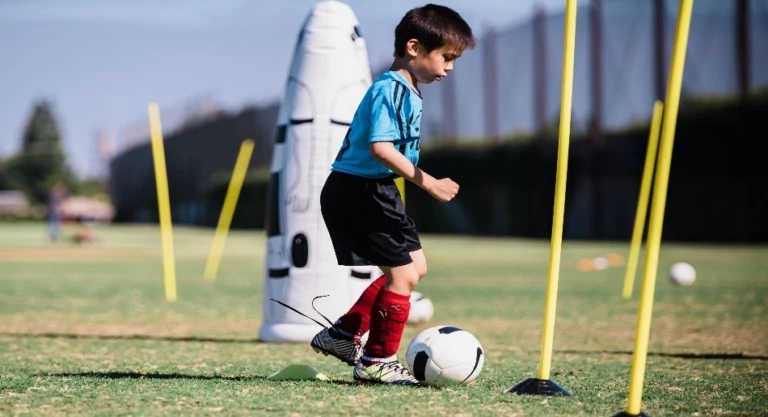 Young Boy kicking ball