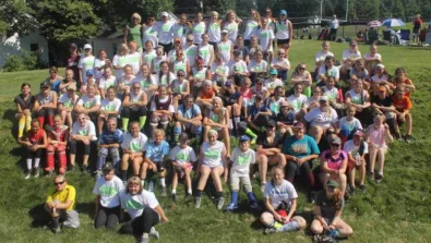 Campers sit on hillside for group picture at Nike Softball Camp Amherst College