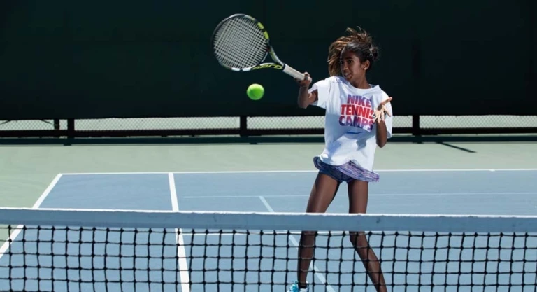 Tennis girl forehand at net
