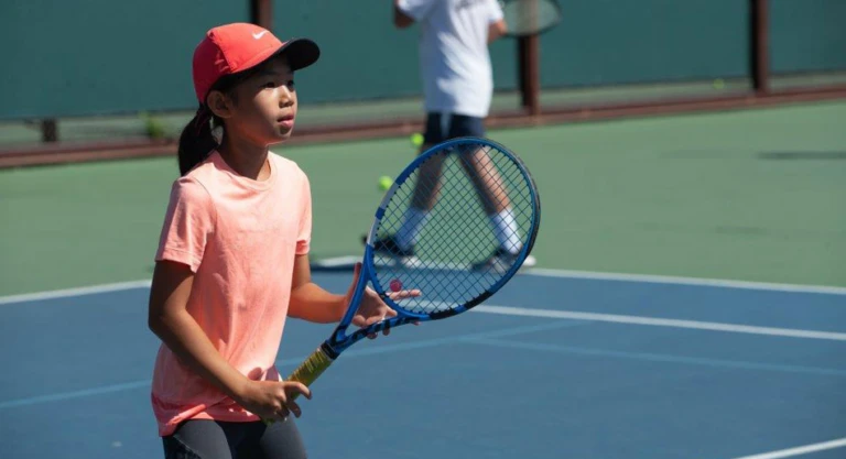 Tennis gril ready stance at net