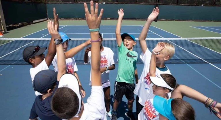 Tennis kids hands in the air