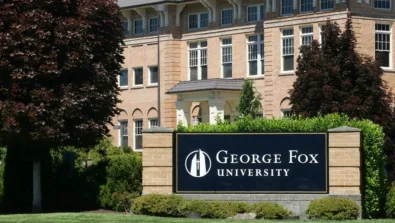 George Fox University campus sign in front of brick building