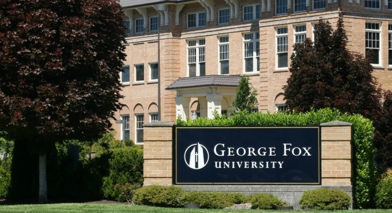 George Fox University campus sign in front of brick building